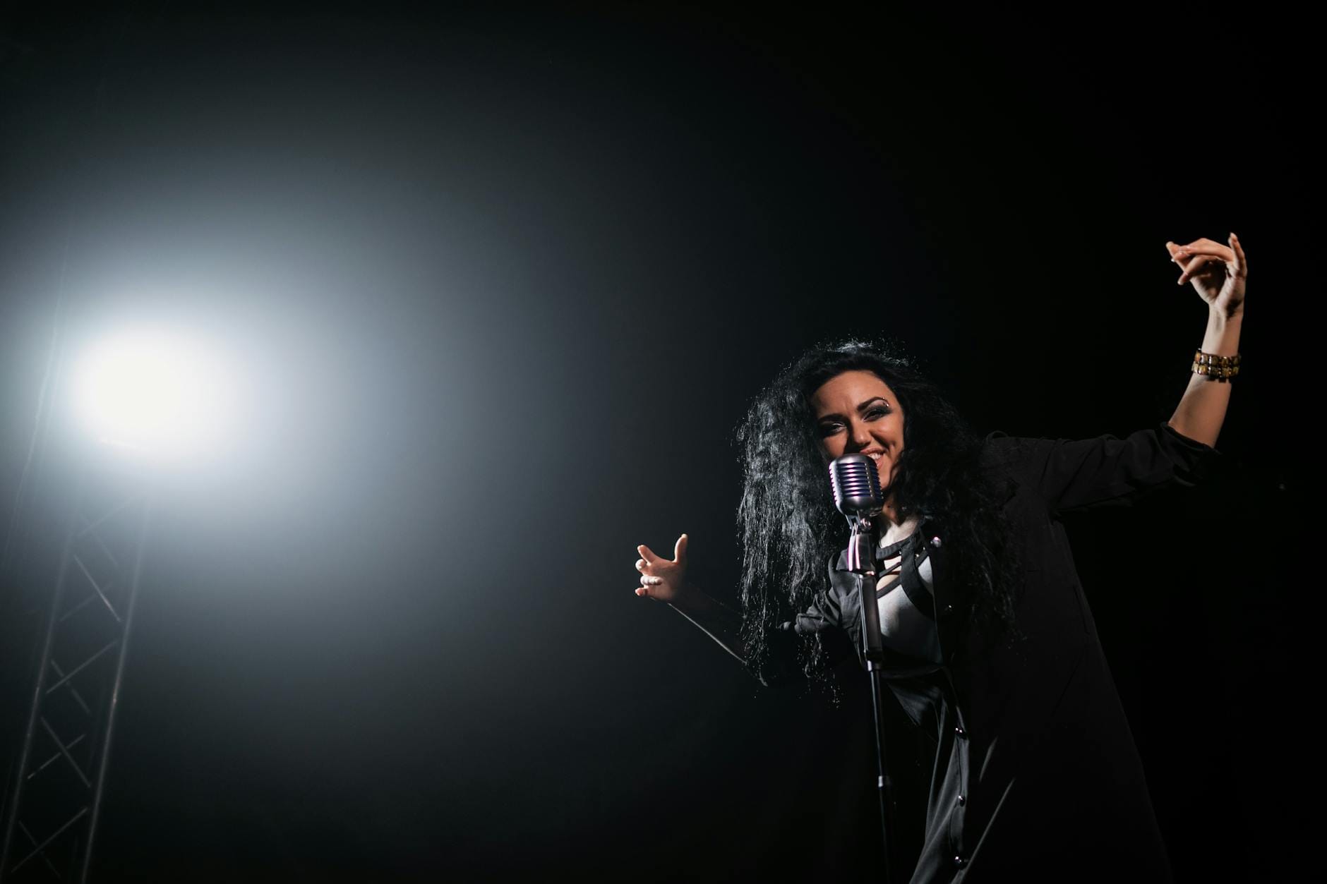 Wokalistka w świetle reflektorów śpiewa ekspresyjnie na scenie